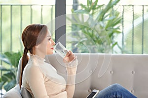 Woman drink water and feel happily at home