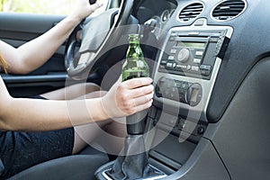 Woman drinking alcohol in the car.