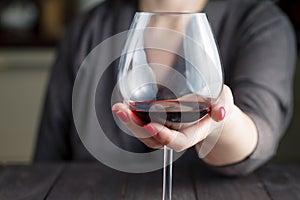 Woman drinking alcohol on dark background