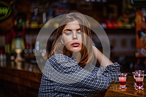 Woman drinking alcohol. Scotch whiskey glass isolated at bar or pub in alcohol abuse and alcoholic concept. Drunk woman