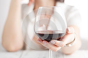 Woman drinking alcohol on white background. Focus on wine glass