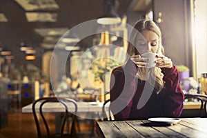 Woman drinking in a cafe