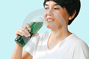 Woman drinking chlorophyll water photo