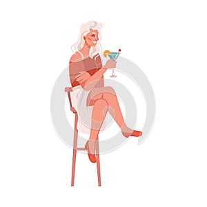 Woman drinking cocktail on barstool
