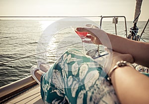 Woman drinking cocktail on the boat