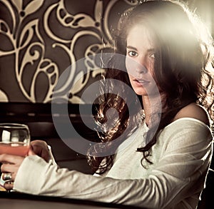 Woman drinking cocktail in cafe bar photo