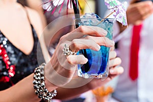 Woman drinking cocktails in cocktail bar