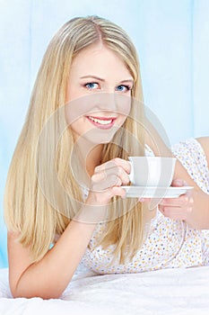 Woman drinking coffee in bed