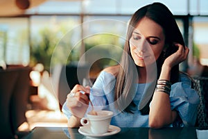 Woman Drinking Coffee by Herself in a Restaurant
