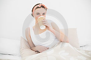 Woman drinking coffee looking into the camera