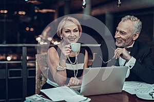 Woman drinking coffee and Man looks at her