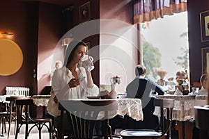 Woman drinking coffee in the morning at restaurant soft focus.
