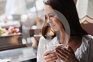 Woman drinking coffee in the morning at restaurant soft focus.