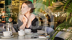 Woman drinking coffee in the morning at restaurant soft focus on the eyes