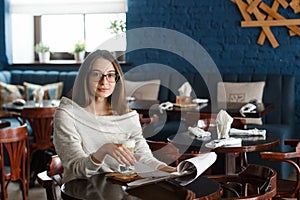 Woman drinking coffee in the morning at restaurant soft focus on the eyes