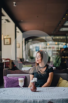 Woman drinking coffee in the morning at restaurant soft focus. Smiling pretty girl with cup of cappuccino. lady enjoy