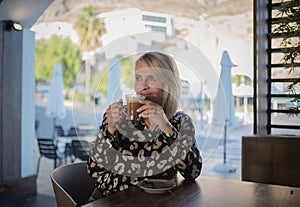 woman drinking coffee in the morning at restaurant.