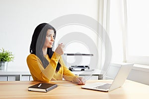 Woman drinking coffee in the office