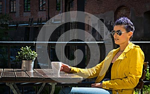 Woman drinking coffee outside