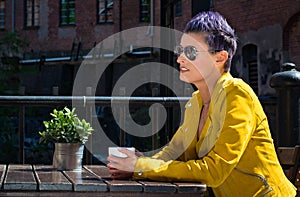 Woman drinking coffee outside