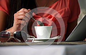 Woman drinking coffee and reading the e-book