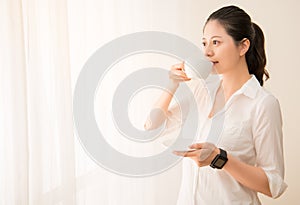 Woman drinking coffee with smart watch