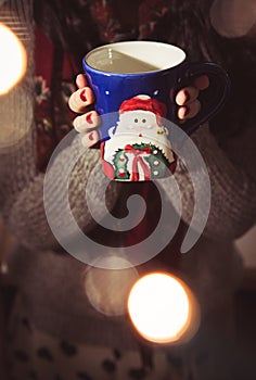 Woman drinking coffee/tea/hot chocolate during the Christmas season