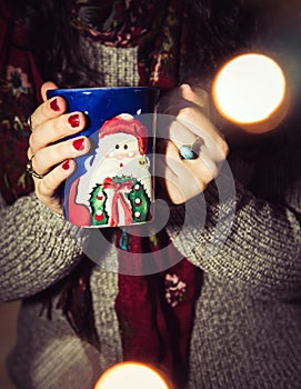 Woman drinking coffee/tea/hot chocolate during the Christmas season
