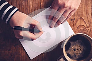 Woman drinking coffee and writing letters