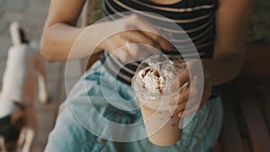 Woman drinking cold coffee with whipped cream