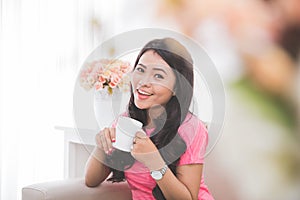 Woman drinking a cup of tea or coffee