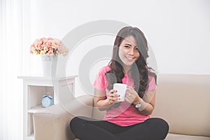 Woman drinking a cup of tea or coffee