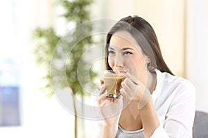 Woman drinking a delicious coffee with milk