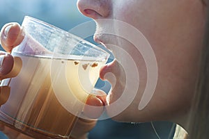 Woman is drinking dirty water from the cup