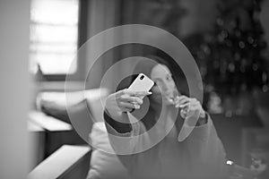 Woman drinking doing selfy at spa