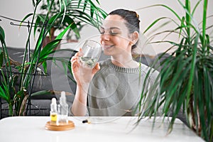 Woman drinking glass with Chlorophyll water, antioxidant beverage. Healthy lifestyle