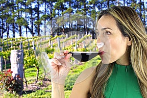 Woman drinking a glass of red Wine