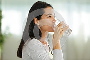 woman drinking glass water