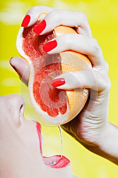 Woman drinking grapefruit juice