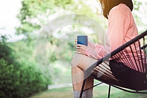 Woman drinking hot coffee at nature in the morning,Enjoys of resting time,Close up