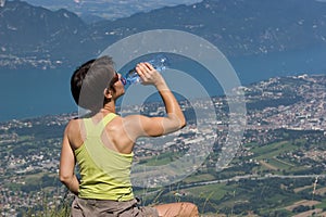 Woman drinking on mountain