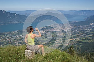 Woman drinking on mountain