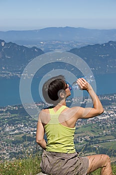 Woman drinking on mountain