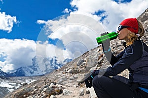 Woman drinking in mountains