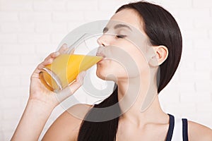 Woman drinking orange juice Beautiful mixed-race Asian, Caucasian model.