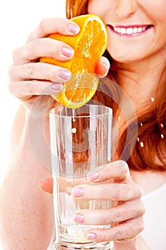 Woman drinking orange juice smiling