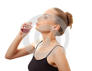 Woman drinking a red liquid