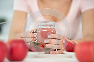 woman drinking red smoothy