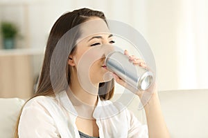 Woman drinking a soda refreshment from a can