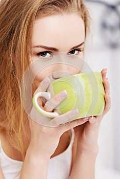 Woman drinking tea in bed